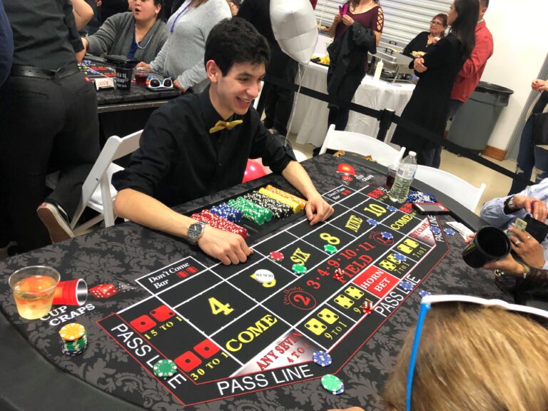 Casino dealer for cup craps at Black Tie Casino Party Rental tables